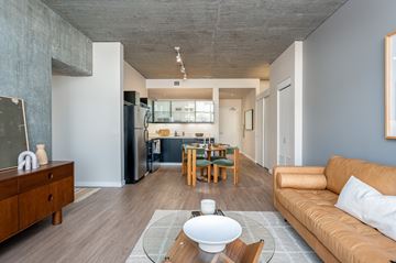 Portland apartment for rent - A modern living room with a brown sofa and a wooden coffee table.