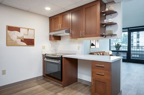 Portland apartment for rent - A kitchen with a white counter top and wooden cabinets.