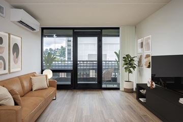 Portland apartment for rent - A living room with a brown couch and a black TV.