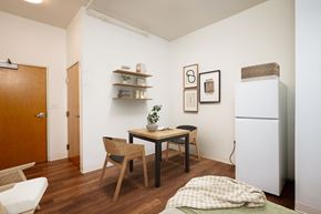 Portland apartment for rent - a small dining room with a table and chairs and a refrigerator