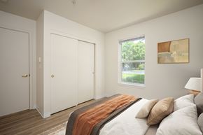 Beaverton apartment for rent - A bedroom with a bed, pillows, and a window.