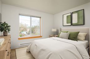 Hilsboro apartment for rent - A bedroom with a large bed and a window overlooking a street.