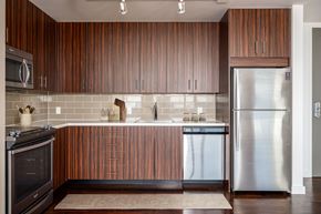 Portland apartment for rent - A modern kitchen with wooden cabinets and stainless steel appliances.