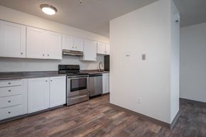 Portland apartment for rent - A kitchen with white cabinets and stainless steel appliances.