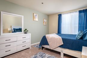 Marysville apartment for rent - A bedroom with a bed, dresser, and mirror.