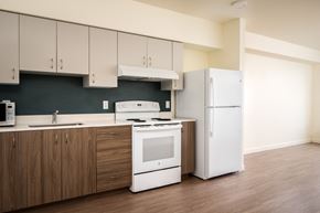 Happy Valley apartment for rent - a kitchen with white appliances and white cabinets and a refrigerator