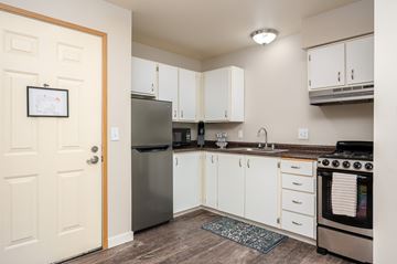 Marysville apartment for rent - A kitchen with white cabinets and a stainless steel refrigerator.
