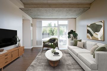 Portland apartment for rent - a living room with a white couch and a coffee table and a large window