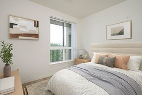 Beaverton apartment for rent - A bedroom with a large bed and a painting on the wall.
