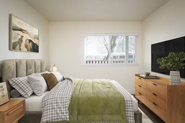 Portland apartment for rent - A bedroom with a bed, nightstand, and a painting on the wall.