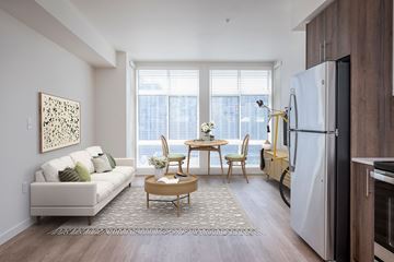 Portland apartment for rent - a living room with a couch and a table and a refrigerator