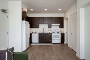 Oregon City apartment for rent - a kitchen with white appliances and dark wood cabinets
