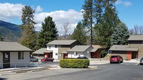 Rogue River apartment for rent - a neighborhood of houses with cars parked in a parking lot