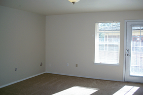 Beaverton apartment for rent - an empty living room with a door and window