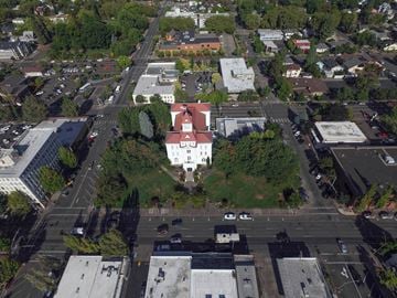 Corvallis apartment for rent - a large white building with a red roof sits in the middle of a city street