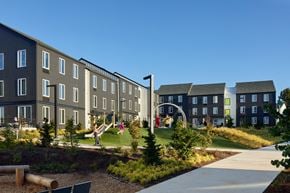 Salem apartment for rent - A playground area in front of a building with a slide and a swing set.