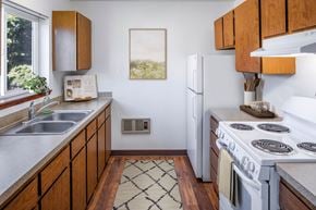 Mcminnville apartment for rent - a kitchen with white appliances and wooden cabinets