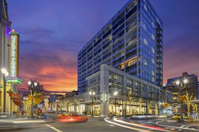 Portland apartment for rent - a city street with a tall building at night