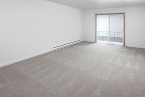 Portland apartment for rent - a bedroom with a large window and a carpeted floor