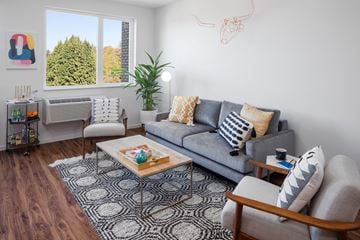 Portland apartment for rent - a living room with a couch and two chairs and a window