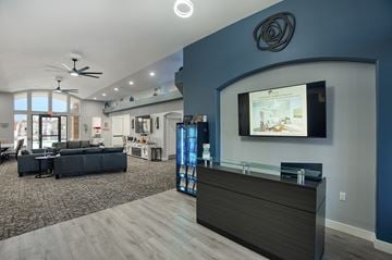 Casa Grande apartment for rent - A modern living room with a dark sofa set and a flat screen TV mounted on the wall.