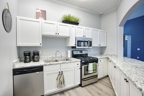 Casa Grande apartment for rent - A kitchen with white cabinets and a black dishwasher.
