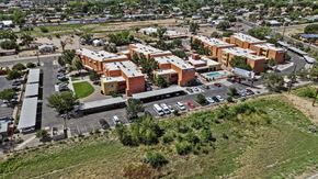 Los Ranchos De Albuquerque apartment for rent - An aerial view of a parking lot with cars and a building complex.