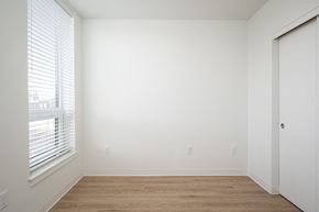 Portland apartment for rent - a bedroom with a large window and a wooden floor