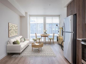 Portland apartment for rent - a living room with a couch and a table and a refrigerator