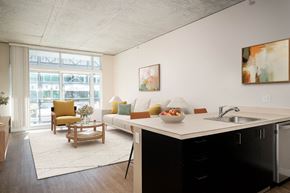 Portland apartment for rent - a living room with a kitchen and a large window