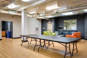 Eugene apartment for rent - a room with a ping pong table and couches