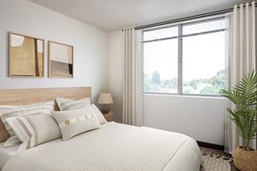 Eugene apartment for rent - a bedroom with a bed and a large window