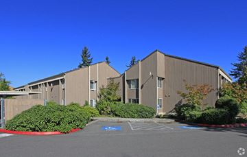 Everett apartment for rent - A large building with a parking lot in front.