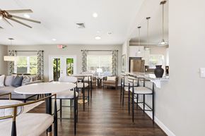 Alabaster apartment for rent - A well-lit, modern dining area with a white table and chairs.