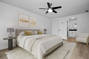 Melbourne apartment for rent - a bedroom with a large bed and a ceiling fan