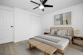 Cocoa apartment for rent - a bedroom with a bed and a ceiling fan