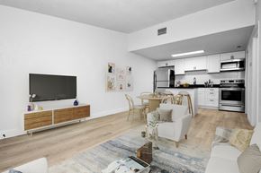 Melbourne apartment for rent - a living room with a couch and a table and a television