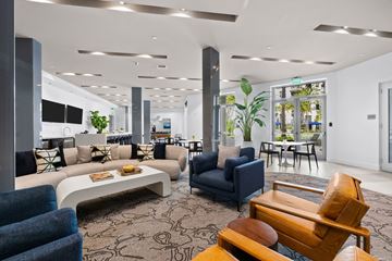 Hallandale Beach apartment for rent - A modern living room with a variety of furniture and plants.