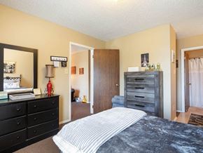Russellville apartment for rent - A Village Square Apartment bedroom with a bed and dresser and a closet