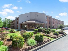 Russellville apartment for rent - The professionally landscaped entrance to Village Square senior apartments in Russellville, AL