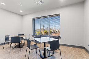 Birmingham apartment for rent - a dining room with a large window and tables and chairs