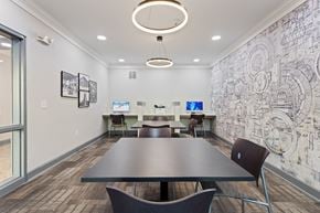 Birmingham apartment for rent - a conference room with a table and chairs and a wall with a mural