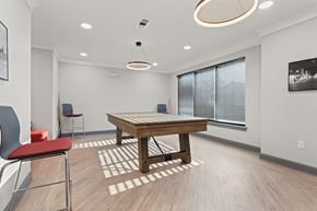 Birmingham apartment for rent - a spacious game room with a pool table and chairs