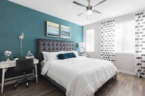 Bradenton apartment for rent - Bedroom with ceiling fan and large windows at Residences at The Green in Lakewood Ranch, FL
