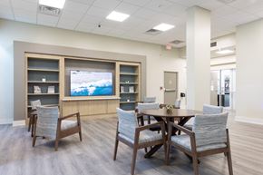 Winter Haven apartment for rent - A conference room with a table, chairs, and a television on the wall.