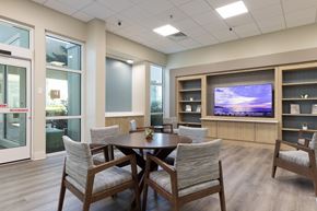 Winter Haven apartment for rent - A modern dining room with a wooden table and chairs.