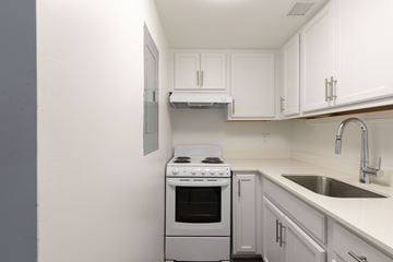 Winter Haven apartment for rent - A white kitchen with a stove and sink.