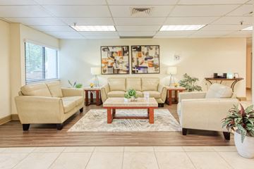 Orlando apartment for rent - a living room with couches and chairs and a table