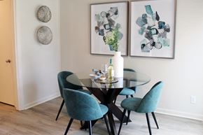 Huntsville apartment for rent - dining room with hardwood-style flooring, model dining set, and wall decor  at Huntsville Landing Apartments, Huntsville, AL, 35806