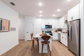 Orlando apartment for rent - A modern kitchen with a dining table and chairs.